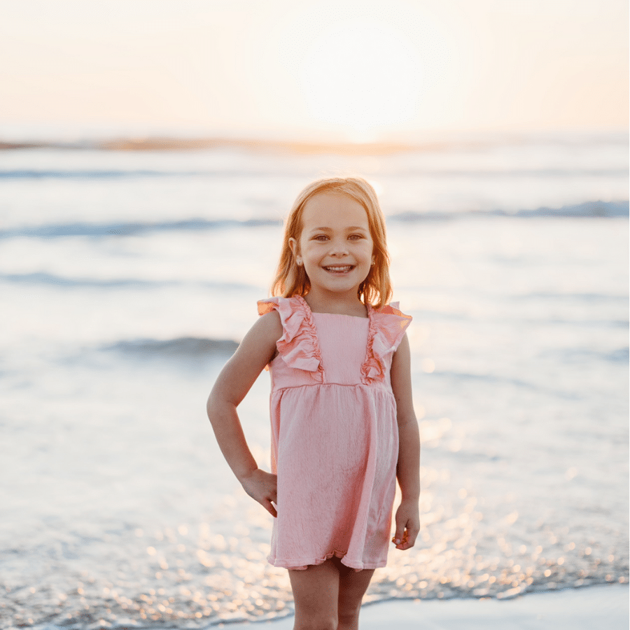 Ella on the beach on her wish trip