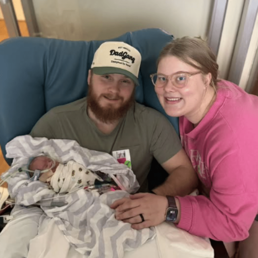 Brooks held by his mom and dad