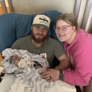 Brooks held by his mom and dad