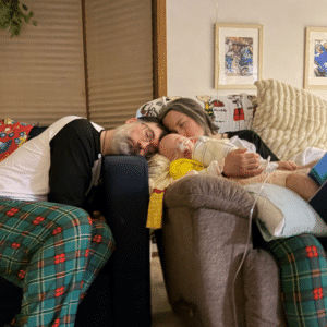 Fulton snuggling with Mom & Dad in his home